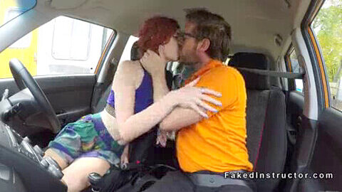 Redhead with perky tits has sex during a driving lesson with her fake instructor