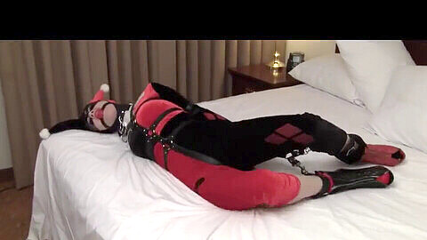 Classic Harley Quinn bound and gagged in kinky domination submission scene