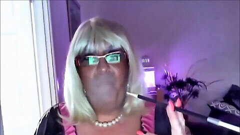 Chrissie shares a smoke with her client on webcam in a crossdressing first-timer experience