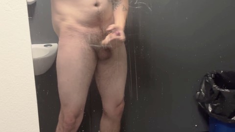 Twink pleasures himself and cums in public bathroom