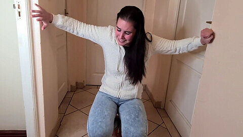 Girl in distress wets her jeans with pee