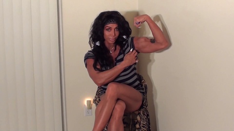 Feast your eyes on the powerful biceps of Mistress Latia, the IFBB Pro female bodybuilding goddess!