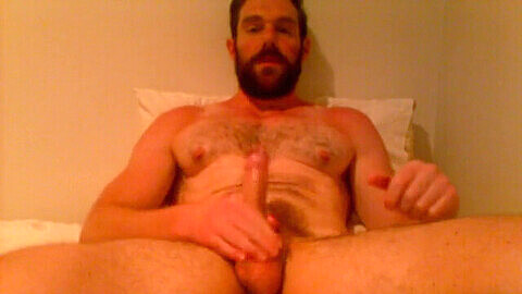 Bearded hunk daddy jerks off in bed and shoots a load on his stomach