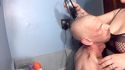 Smooth-shaven, shaving his head, buzzcut