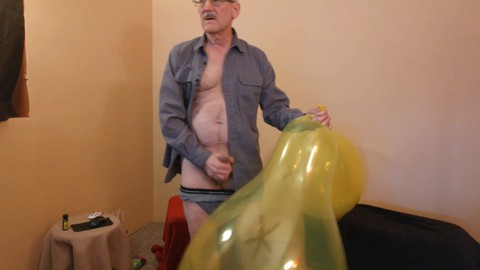 Naughty older man masturbates while enjoying a kinky balloon play